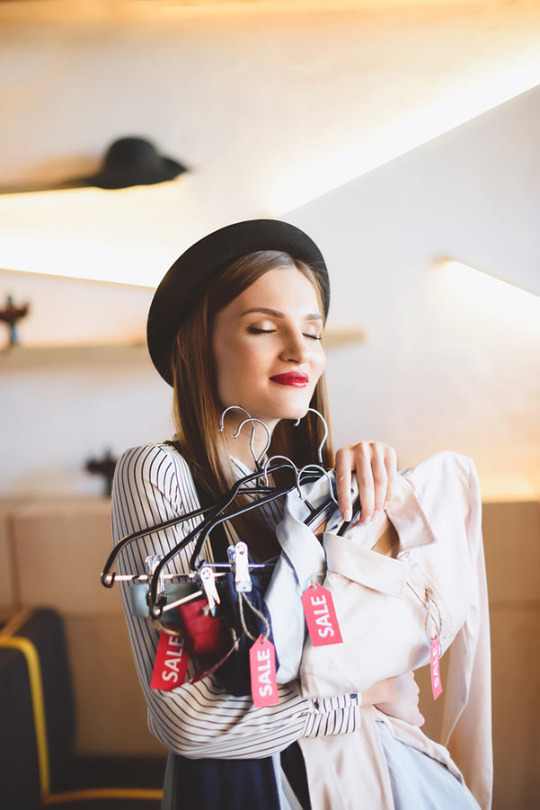 Young woman shopping clothes on sale