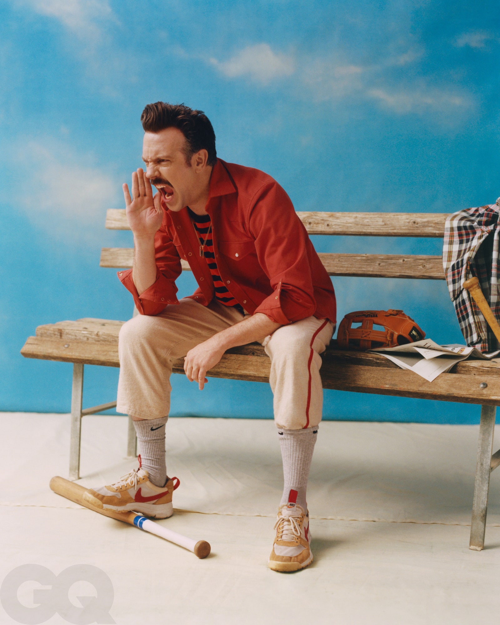 Image may contain Jason Sudeikis Clothing Apparel Human Person Wood Sitting Footwear Shoe and Plywood