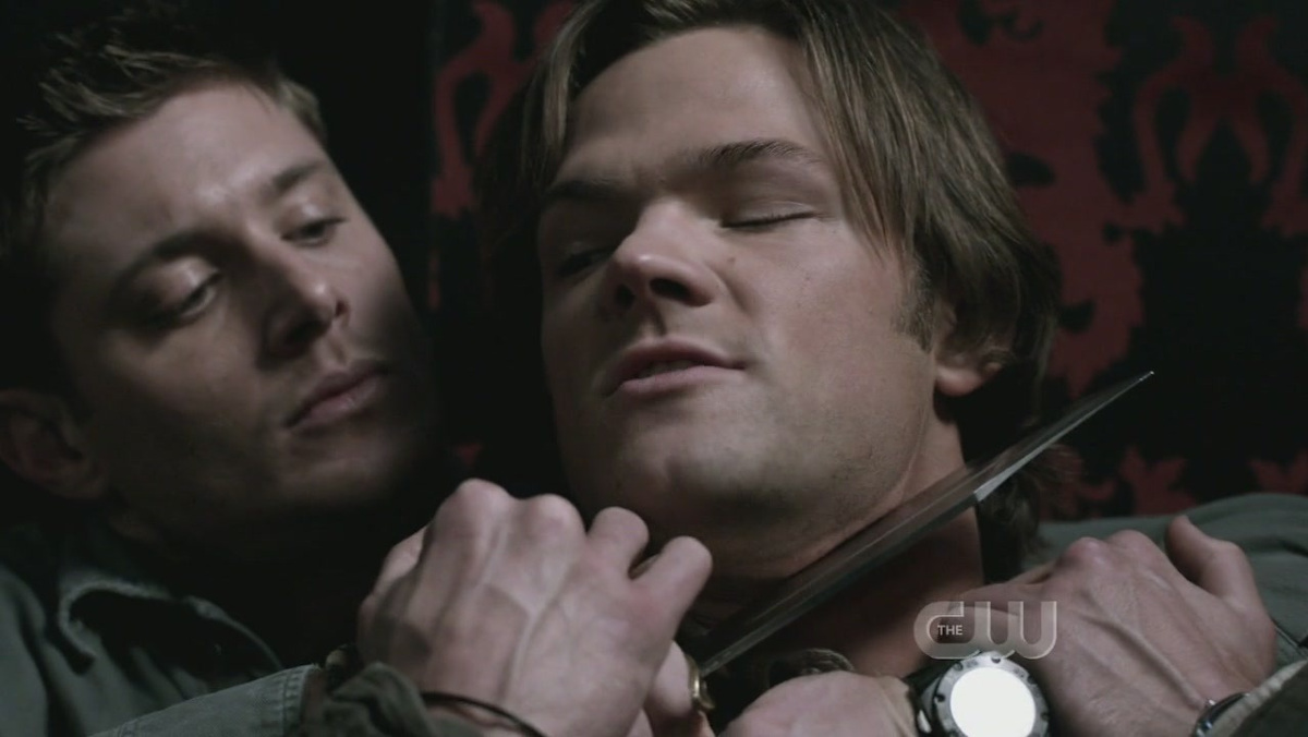 Dean Winchester holding a throat to Sam Winchester's neck in Supernatural
