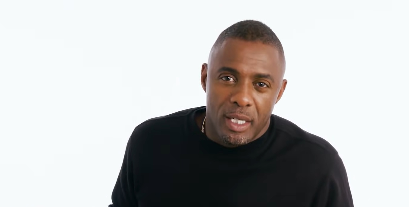 idris elba with a black shirt against a white background