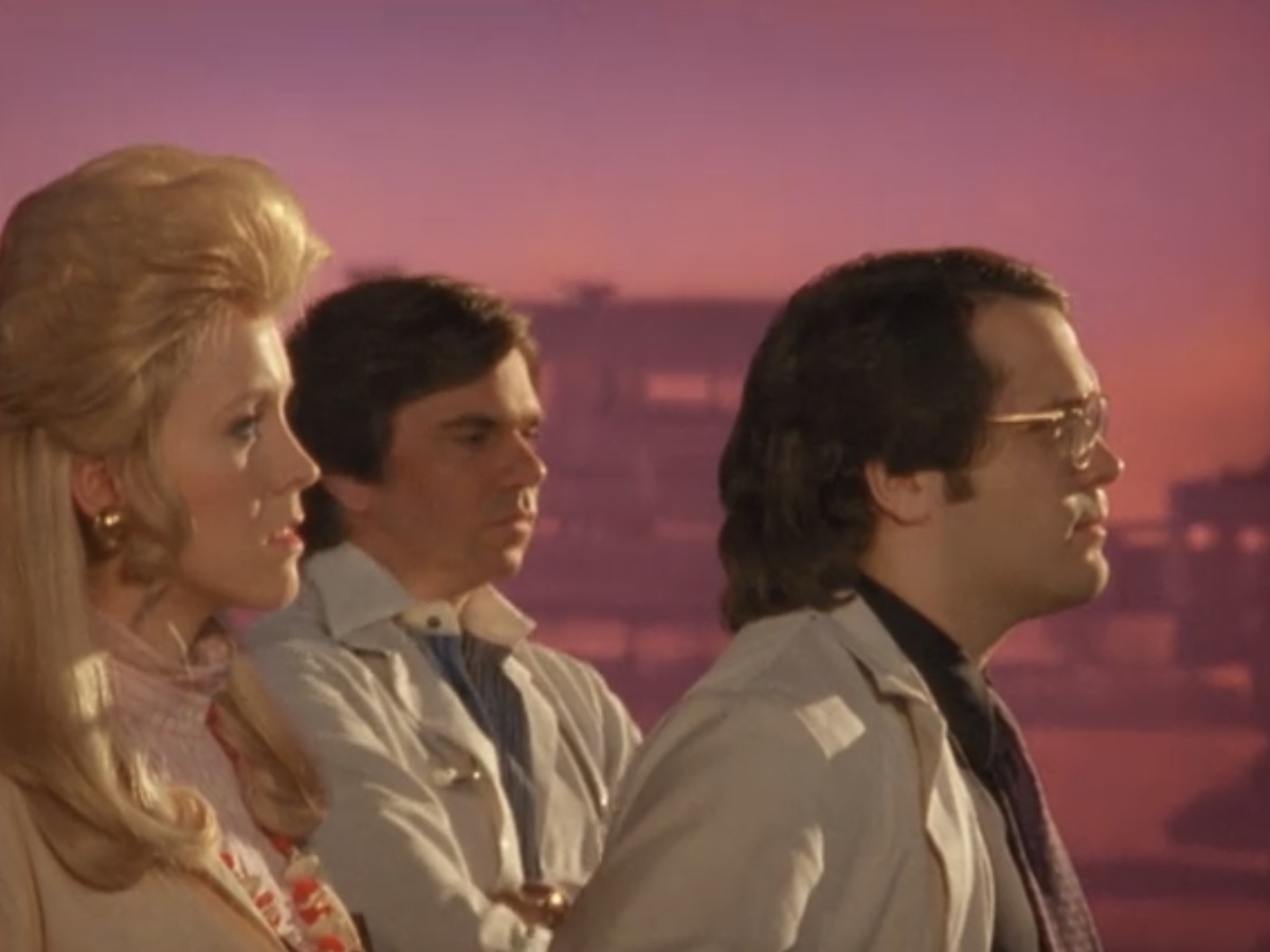 Dagless, Liz, and Sanch look out from the roof on Garth Marenghi's Darkplace
