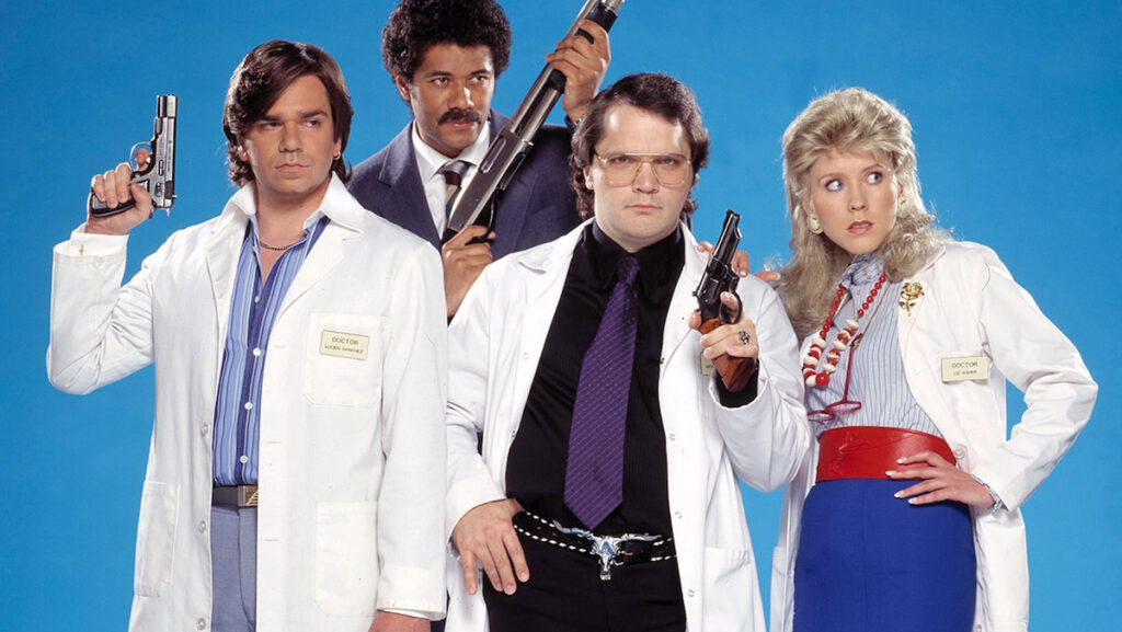 The cast, most holding guns, in a promo photo for Garth Marenghi's Darkplace
