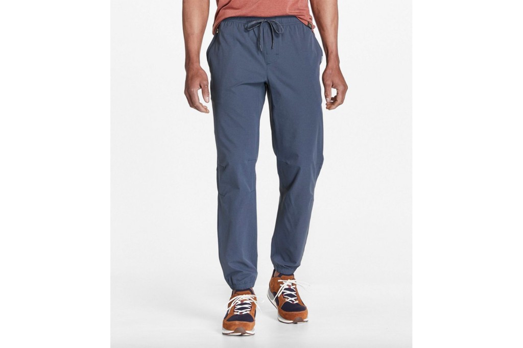 A pair of blue joggers on a man's lower body 