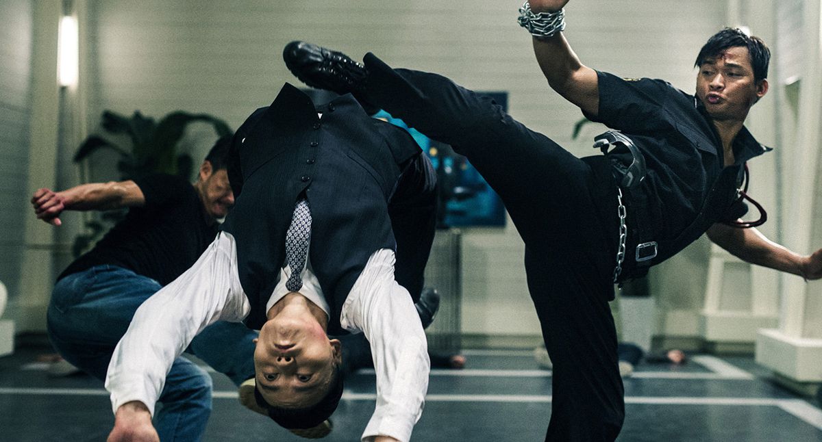 Two men face off in an intense martial arts battle