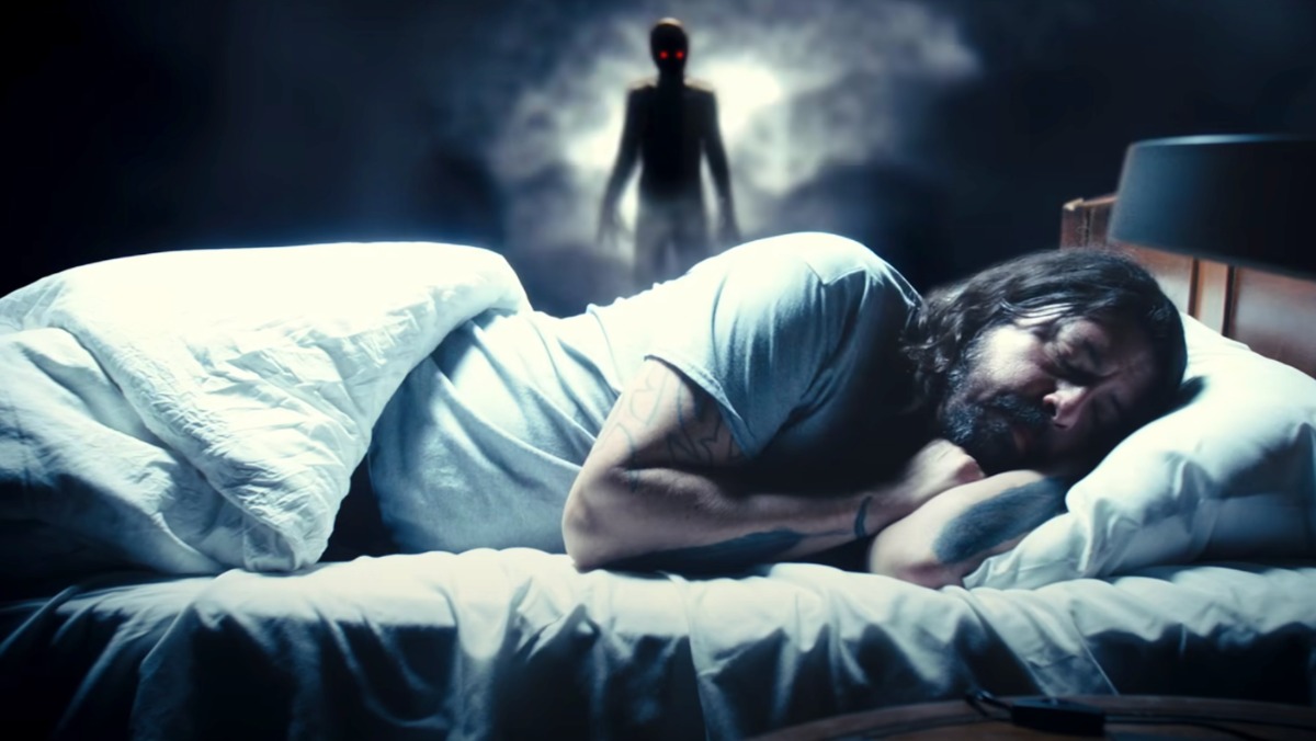 Studio 666 still of Dave Grohl asleep in bed as a monster lurks in the first trailer for the Foo Fighters' movie.