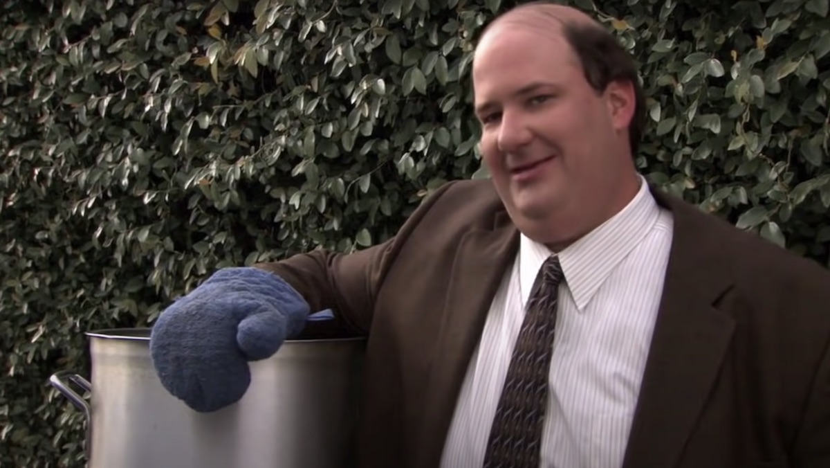 Kevin proudly holds his pot of chili in the parking lot on The Office