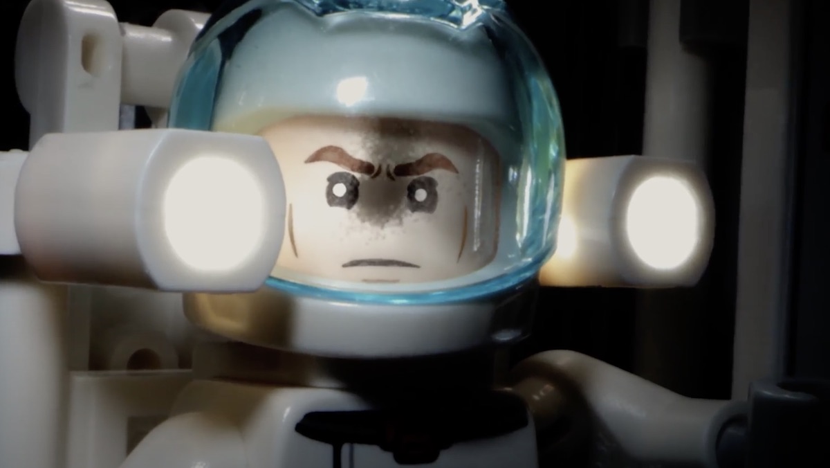 An astronaut's helmet reflects an alien swarm coming at him in a LEGO recreation of Moonfall