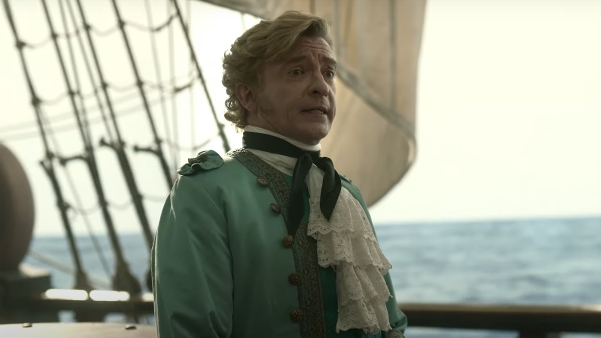 Rhys Darby wears his fancy green captain suit on his ship in Our Flag Means Death