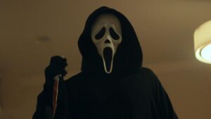 a still from scream (2022) shows ghostface who will return for scream 6 sequel