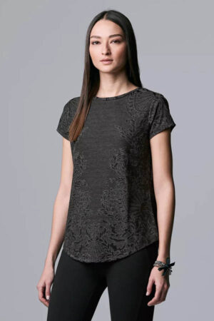 Model wearing black jacquard top by Simply Vera.