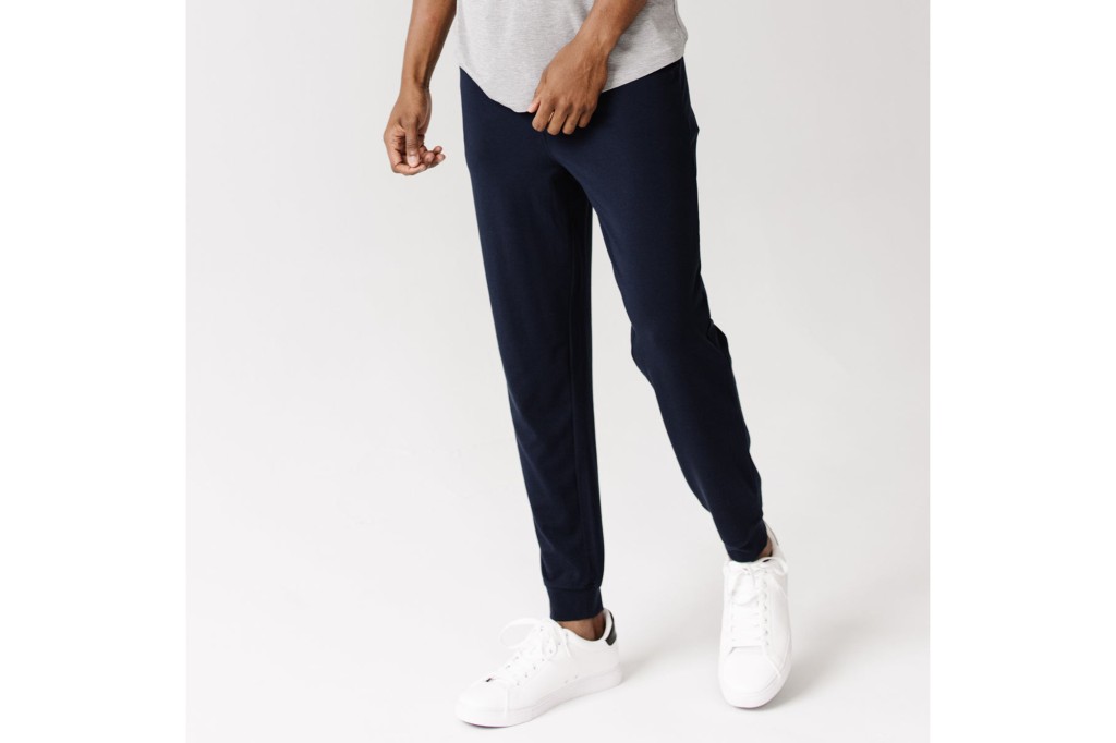 A man in navy blue joggers and a white tee