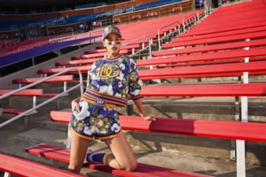 Model wears Dolce & Gabbana look in stadium stands.