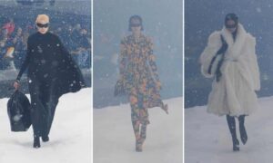 Models at the Balenciaga show walk through fake snow.