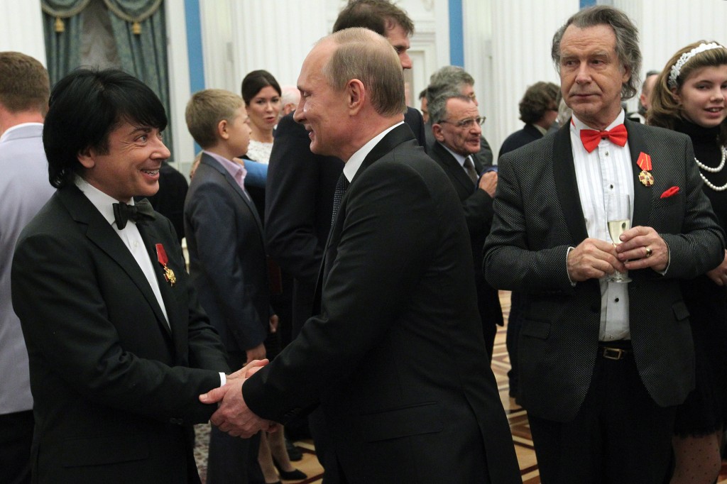 Yudashking shaking Putin's hand at a social gathering.