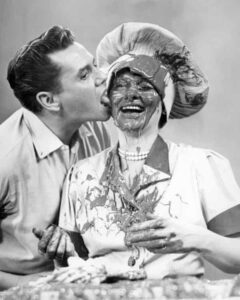 Desi Arnaz licks Lucille Ball’s face In I Love Lucy.