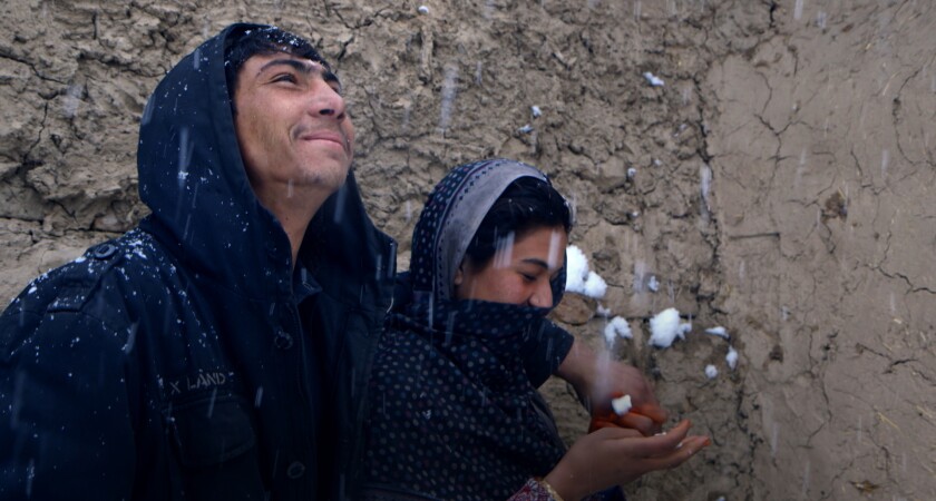 A young Afghan couple enjoys the snow falling in "Three Songs for Benazir." 