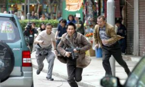 Johnnie To’s film Breaking News (2004) begins with a six-minute street battle filmed with a camera that swoops high and low.