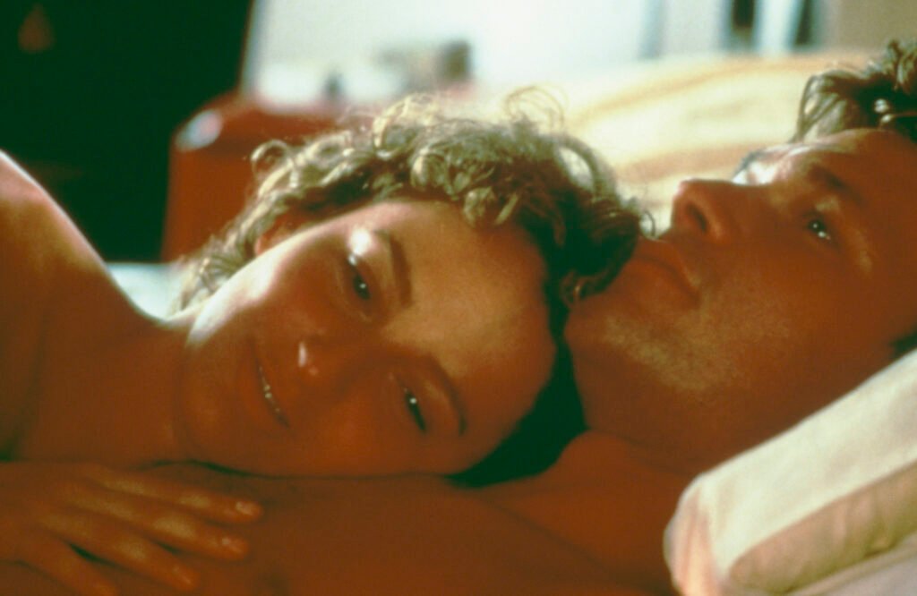 American actors Patrick Swayze (1952 - 2009) and Jennifer Grey enjoy a post-coital moment in the film 