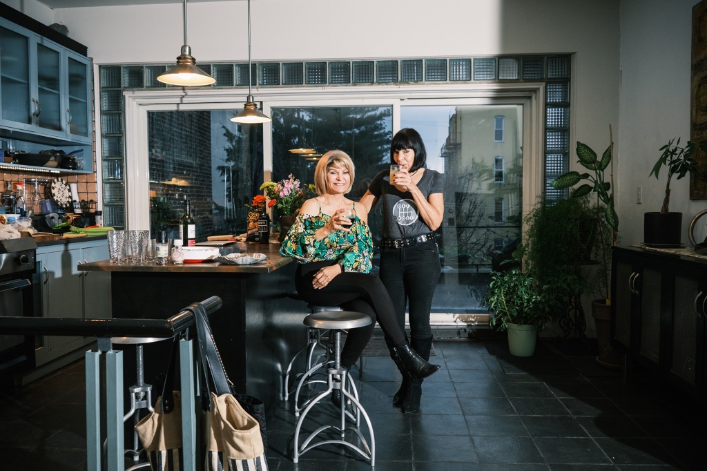 Interior of Donna Carroll, left, and Janet Rutkowski, right, having a drink in the kitchen area.