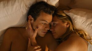 Don't Worry Darling First Look Image featuring Harry Styles and Florence Pugh in bed.