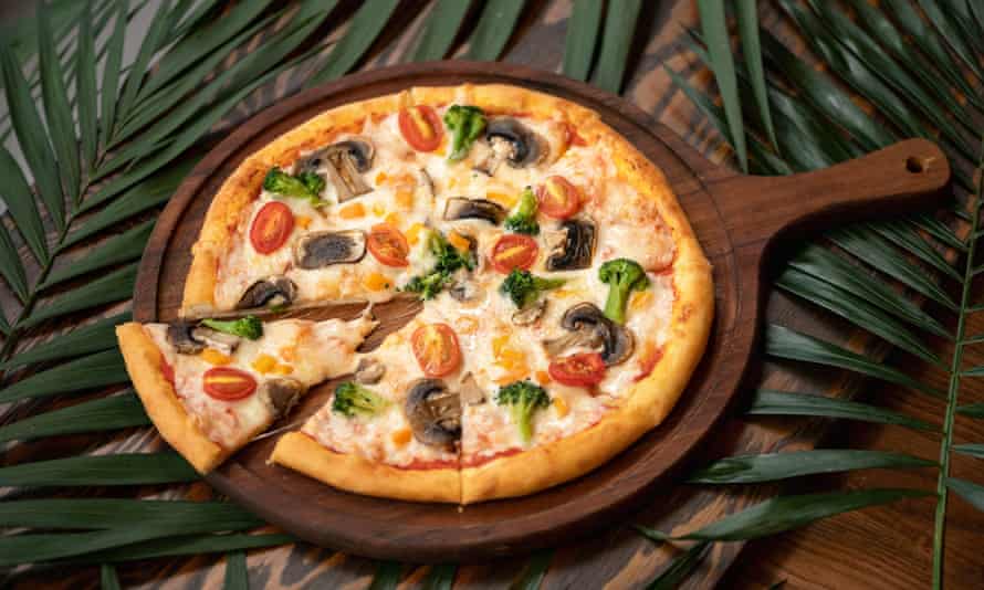 Pizza with broccoli, mushrooms and tomatoes.