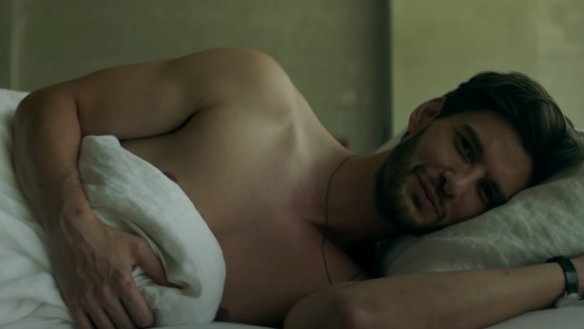 Ben Barnes lying shirtless in his bed in the 11:11 music video