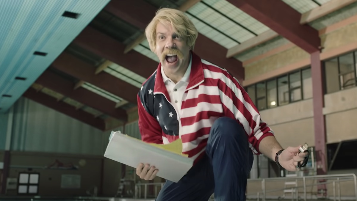 Jason Sudeikis plays a blonde hair and mustachioed coach in an American flag jacket in the Foo Fighters' music video for Love Dies Young