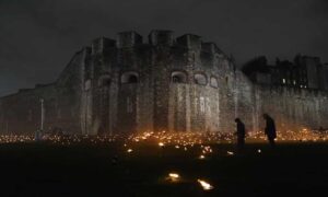 Thousahnds of burning torches in the moat around the Tower of London