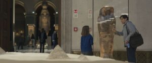 Steven Grant shows a sarcophagus to a little girl in a museum. There’s a QR code on the wall nearby, in Moon Knight.