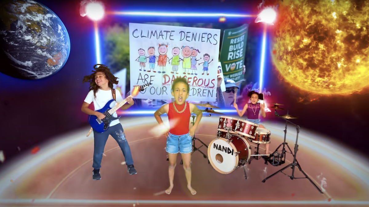 Nandi Bushell sings and plays drums with Roman Morello on guitar in front of a collage of climate change images