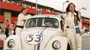 lindsay lohan standing next to herbie the car