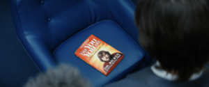 Ricken’s book sitting on a blue chair with the innies of Lumon looking down on it