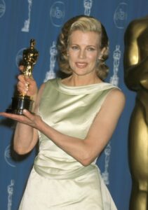 Kim Basinger holding her Oscar at the 1998 Academy Awards