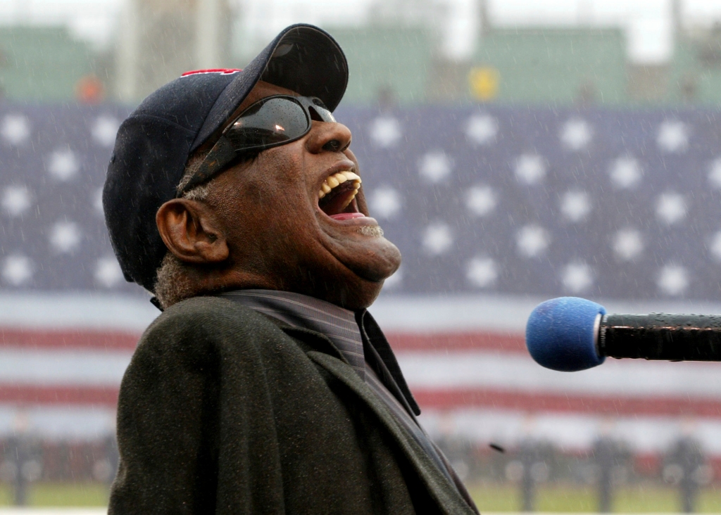 Ray Charles sings "America The Beautiful," in the rain at Fenway Park in Boston, April 11, 2003.