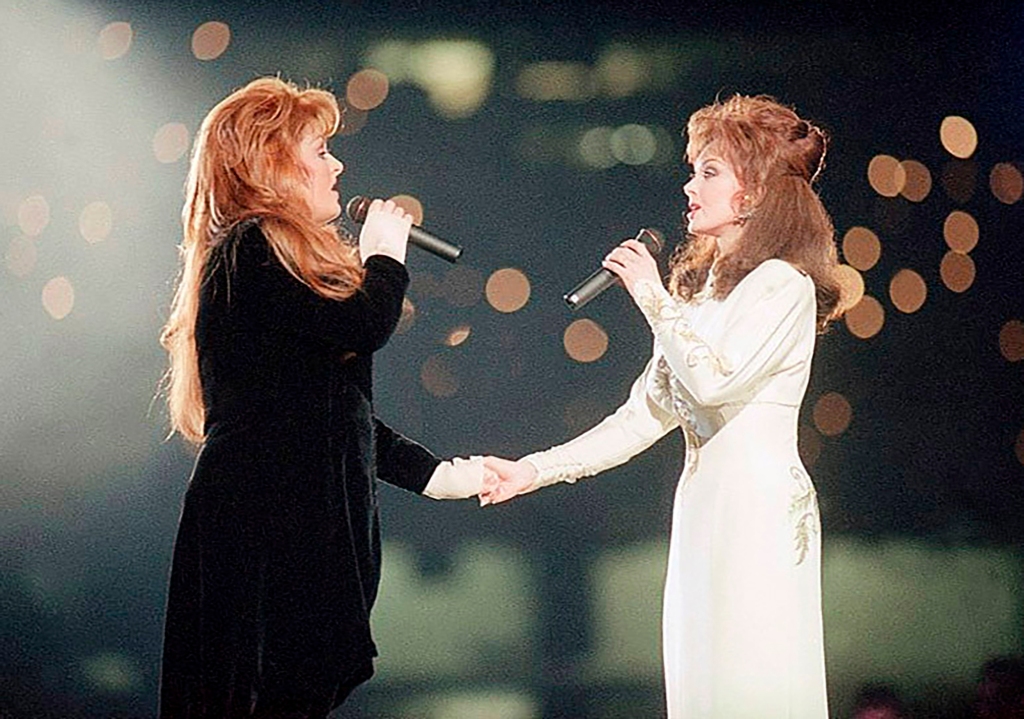 Wynonna Judd, left, and her mother, Naomi Judd, of The Judds, perform during the halftime show at Super Bowl XXVIII in Atlanta on Jan. 30, 1994.