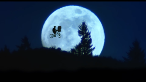 Elliott rides his bike in front of the moon in this shot from E.T. The Extraterrestrial