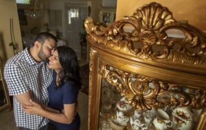 Adil Sheikh, left, kiss his wife, Safia Sheikh, right, on the cheek.