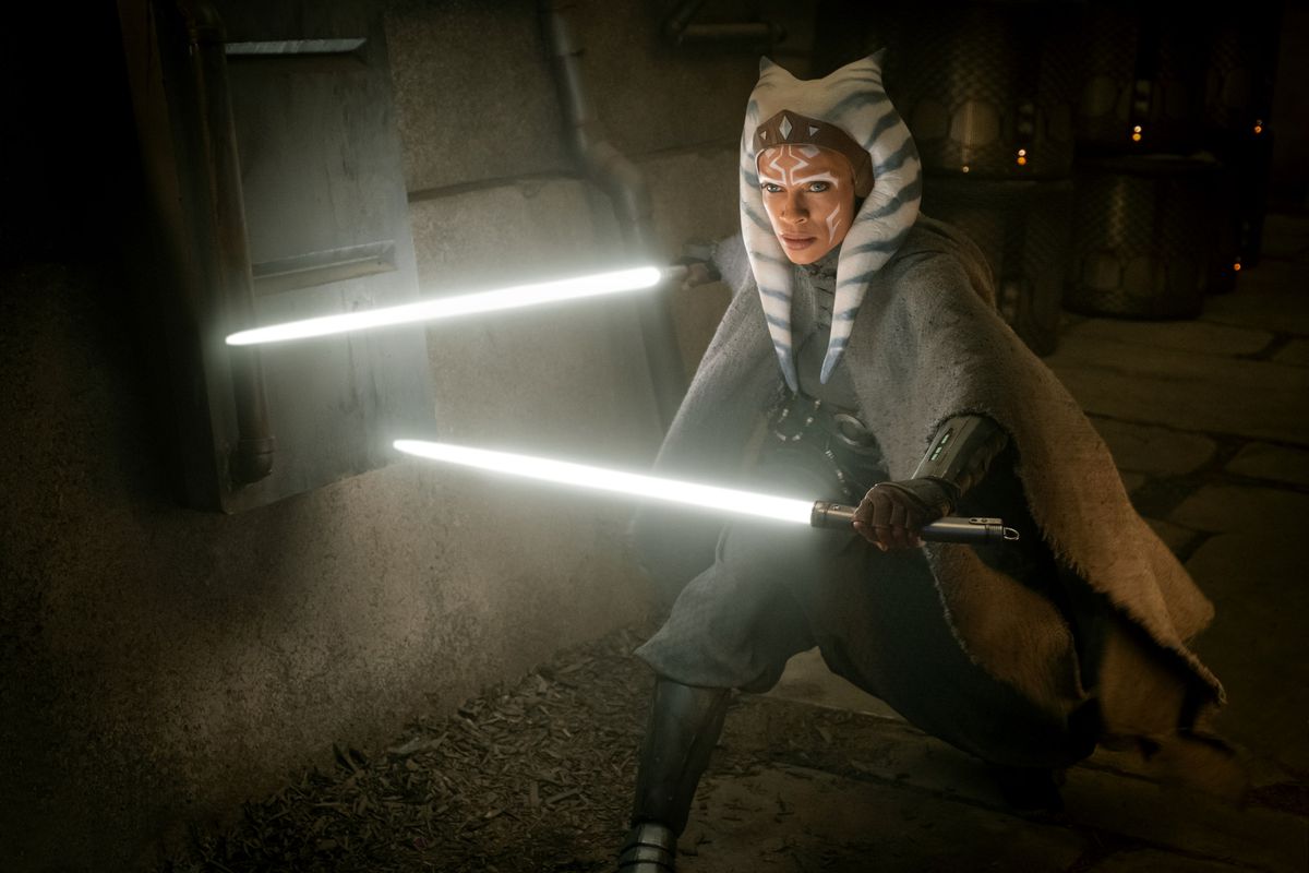 Rosario Dawson as Ahsoka Tano in The Mandalorian wielding two white lightsabers