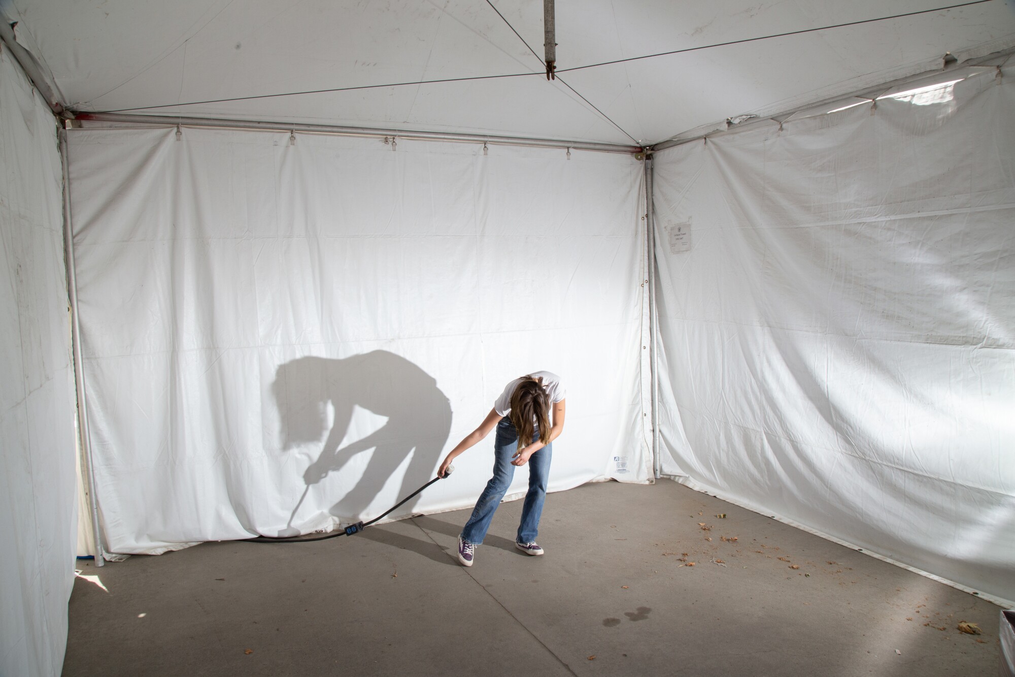 A festivalgoer poses in a pop-up tent.