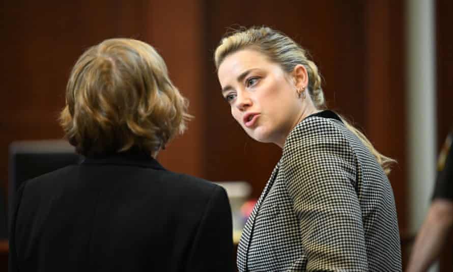 Amber Heard speaks with her attorney Elaine Bredehoft in court.