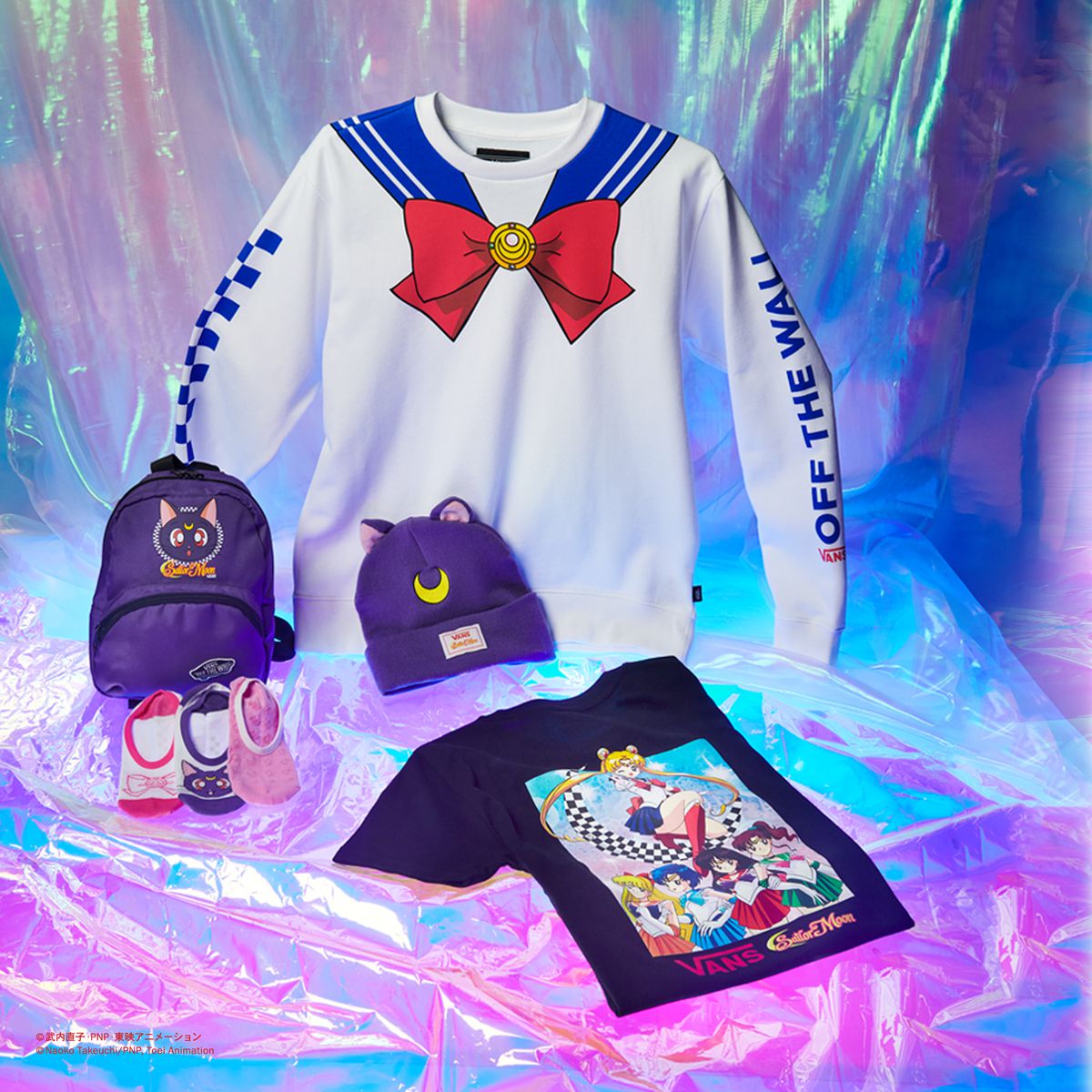 A long sleeve shirt with a design that looks like a Sailor Guardian, a backpack, a T-shirt, and a beanie