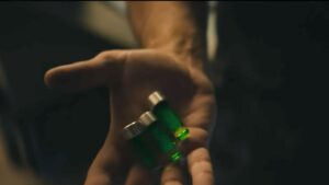 a photo of three green vials in the palm of butcher on the boys compound v24