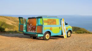 Scooby Doo's Mystery Machine with the doors open near the beach