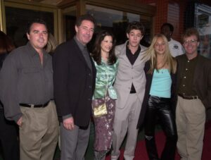 Cast members, from left, Christopher Knight , Barry Williams, unidentified woman, Adam Brody, Kaley Cuoco, and Michael Lookinland pose, May 15, 2000, during the premiere screening of "Growing Up Brady."