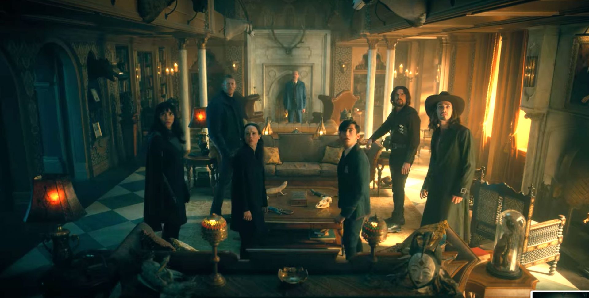 An image from the finale of Umbrella Academy S2 shows the team looking in shock behind them as Reginald Hargreeves stands in front of them