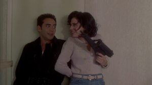 Mark Dacascos and Brittany Murphy holding an uzi in Drive.