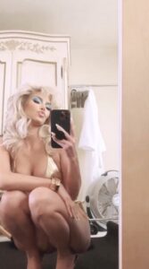 Kim Kardashian flaunts her curves in a mirror selfie as she blows a kiss to her followers