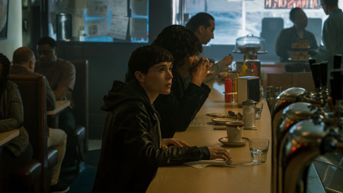 photo of Viktor Hargreeves in Umbrella Academy season three sitting at a bar with Allison