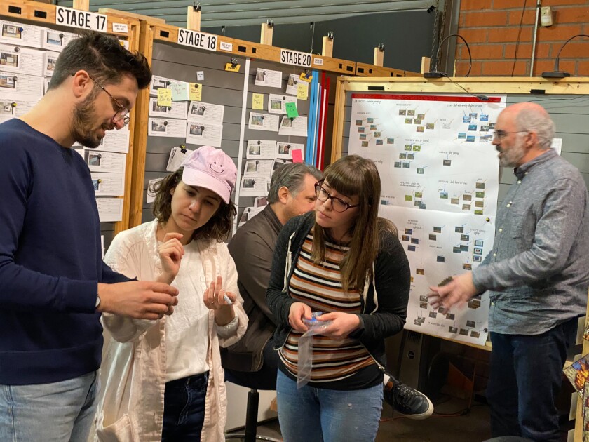 Members of Lepore's production team examine "Marcel the Shell With Shoes On."