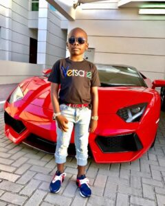 Designer-clad Mompha Junior, 10, poses with his Lamborghini
